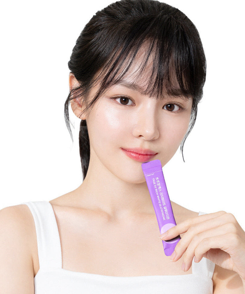 Woman holding TRUE RX Rich White Glutathione stick from 10 packs