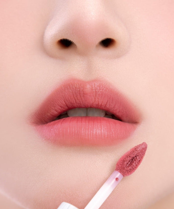 Close-up application of UNLEASHIA Clound Kiss Velvet Tint on lips, showcasing the vibrant color and smooth texture.