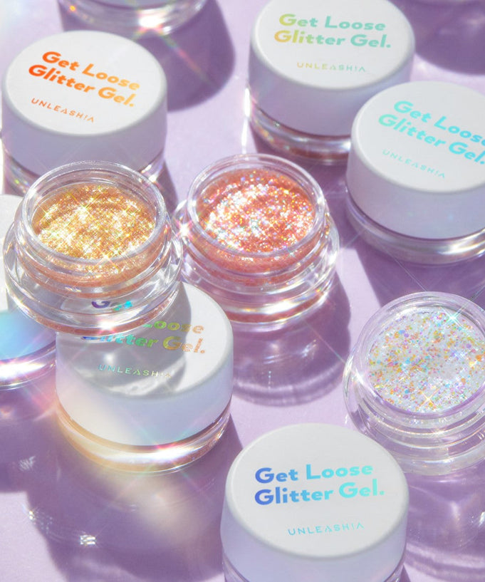 UNLEASHIA Get Loose Glitter Gel (#01 to #07) showcasing vibrant, shimmering glitter shades in clear containers on a reflective surface.