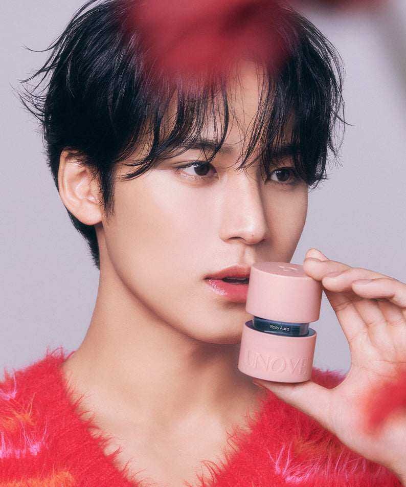 Person holding UNOVE Eau De Parfume bottle close to face