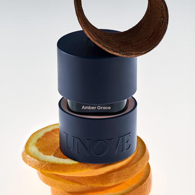 UNOVE Eau De Parfume bottle with citrus slices and a spiral decoration