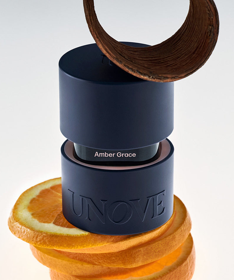 UNOVE Eau De Parfume bottle with citrus slices and a spiral decoration