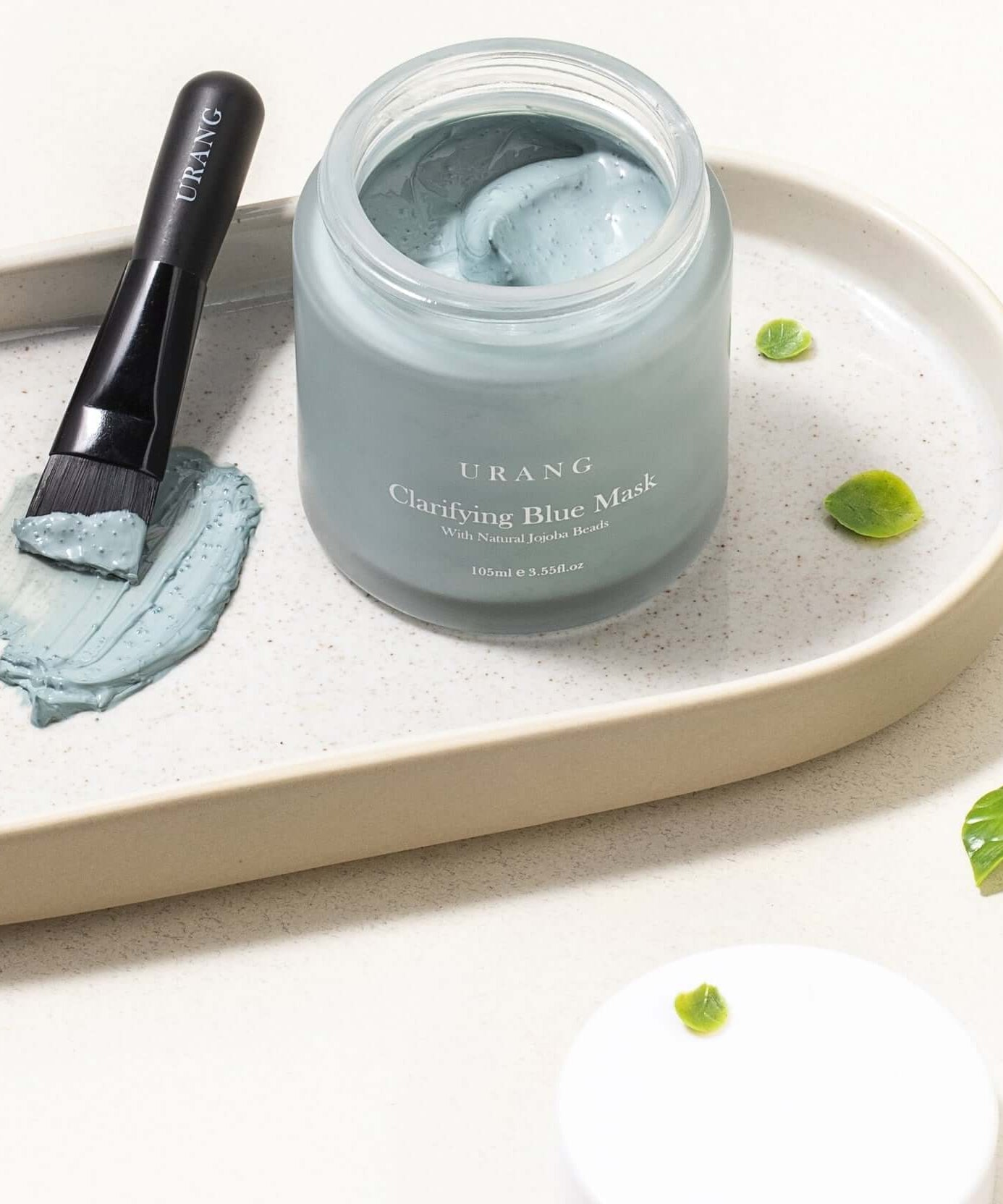 URANG Clarifying Blue Mask with applicator brush on a tray, showcasing skincare product.