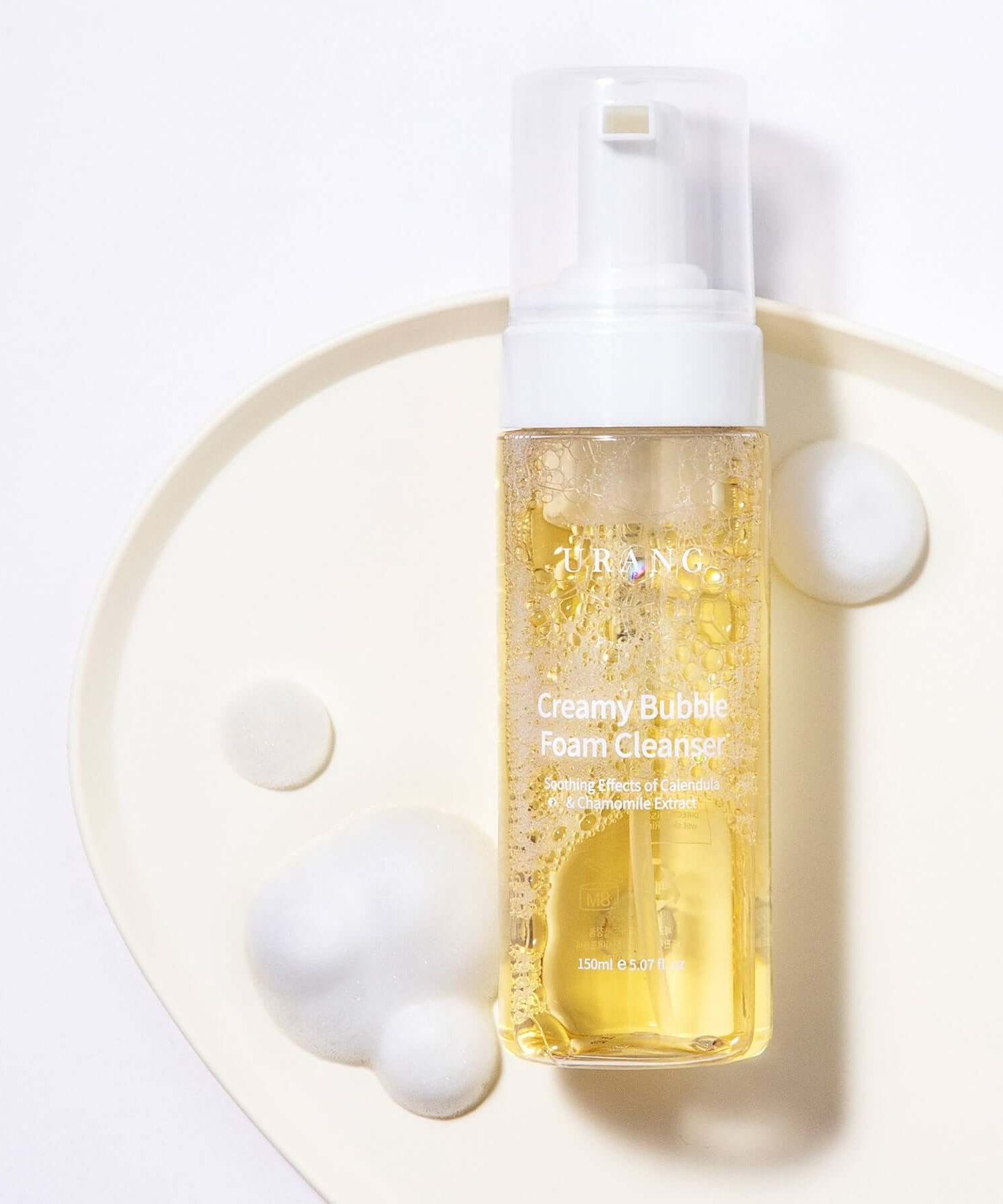 URANG Creamy Bubble Foam Cleanser 150ml bottle with foam on a white tray.
