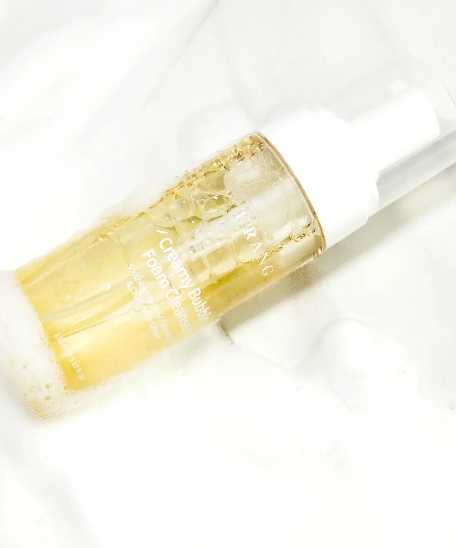 URANG Creamy Bubble Foam Cleanser 150ml bottle on a foamy background, showcasing its gentle and effective cleansing formula.