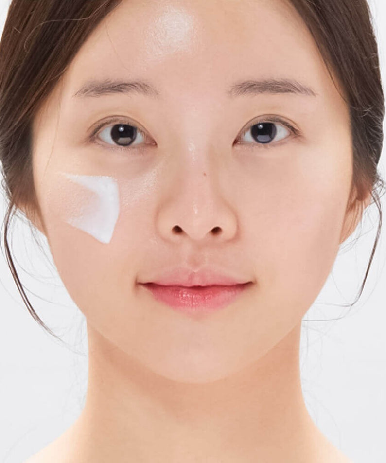 Woman applying VT COSMETIC PDRN Moist Tone-Up Sun Essence RX 60ml on face