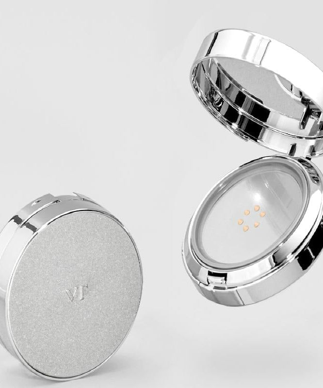 VT COSMETIC Riddle Shot Synergy Cushion 15g with open and closed case showing makeup cushion detail on a sleek, silver compact.