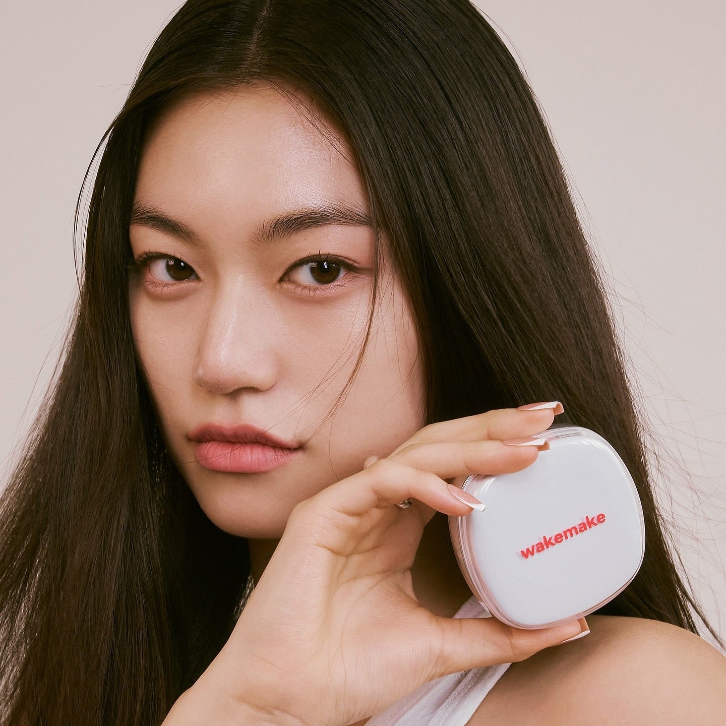 Woman holding WAKE MAKE Seamless Wear Cushion 15g