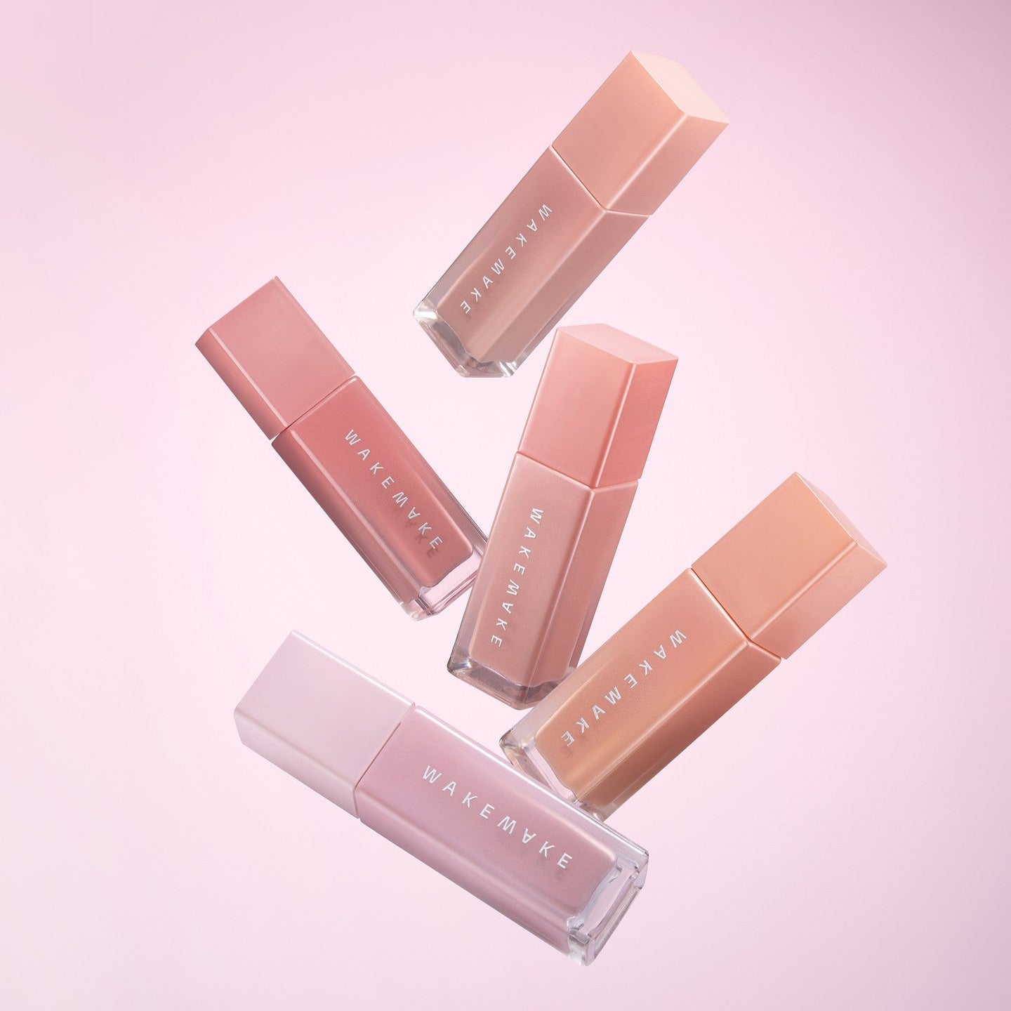 WAKE MAKE Sheer Glow Liquid Blusher 7g collection in various shades against pink background