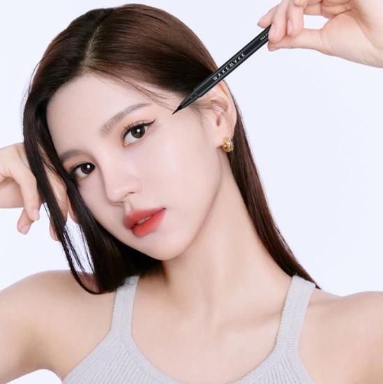 Woman applying WAKEMAKE Any Proof Eyeliner for precise eye makeup look.
