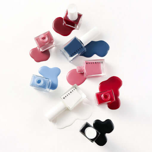 Colorful array of nail polish bottles from WAKEMAKE Nail Gun (#08 to #167) showcasing various shades.