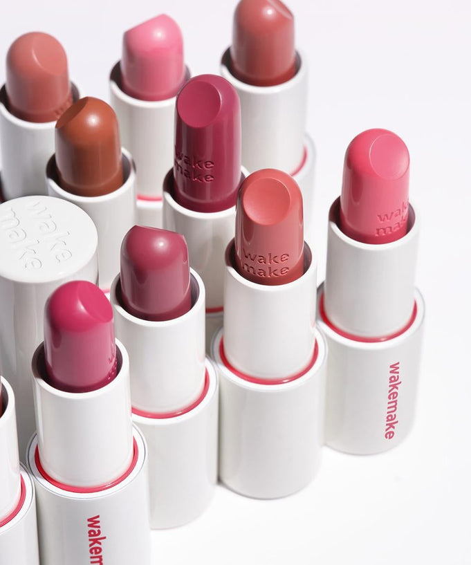 WAKEMAKE Healthy Glow Balm Sticks in various colors arranged in a row, showcasing luxurious moisturizing lip care.