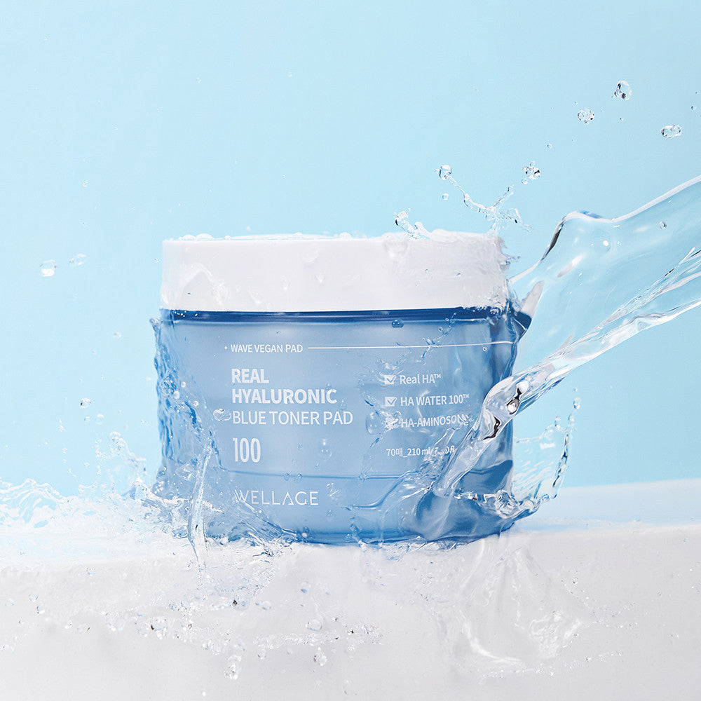 WELLAGE Real hyaluronic Blue Toner Pads 70 Sheets on a light blue background with splashing water for hydration and skincare