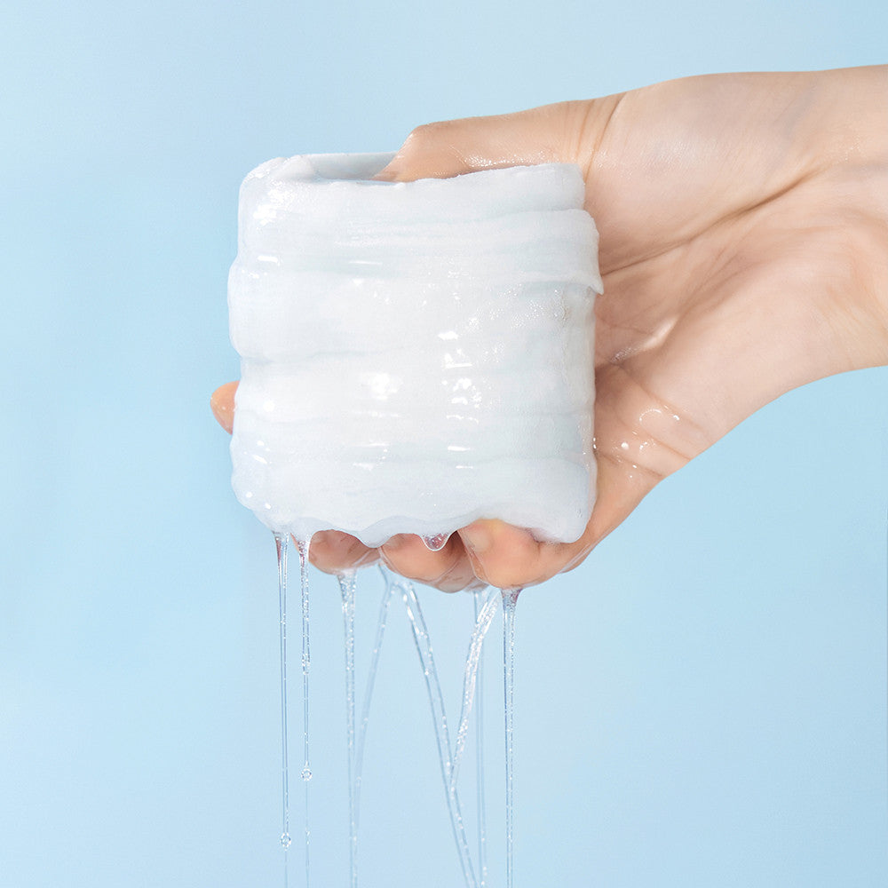 WELLAGE Real hyaluronic Blue Toner Pads 70 Sheets being squeezed with liquid dripping from a hand