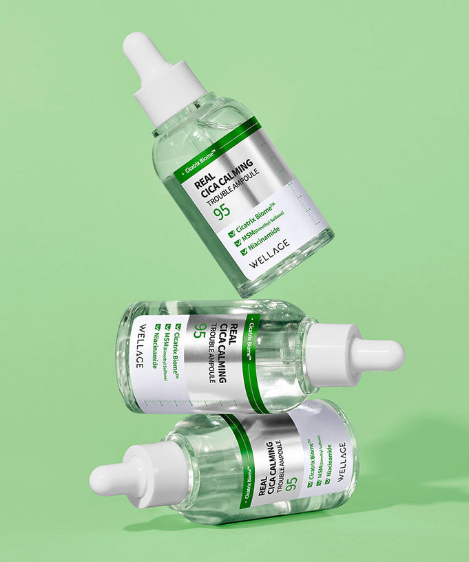 WELLAGE Real Cica Calming 95 Trouble Ampoule 50ml skincare product bottles on a green background