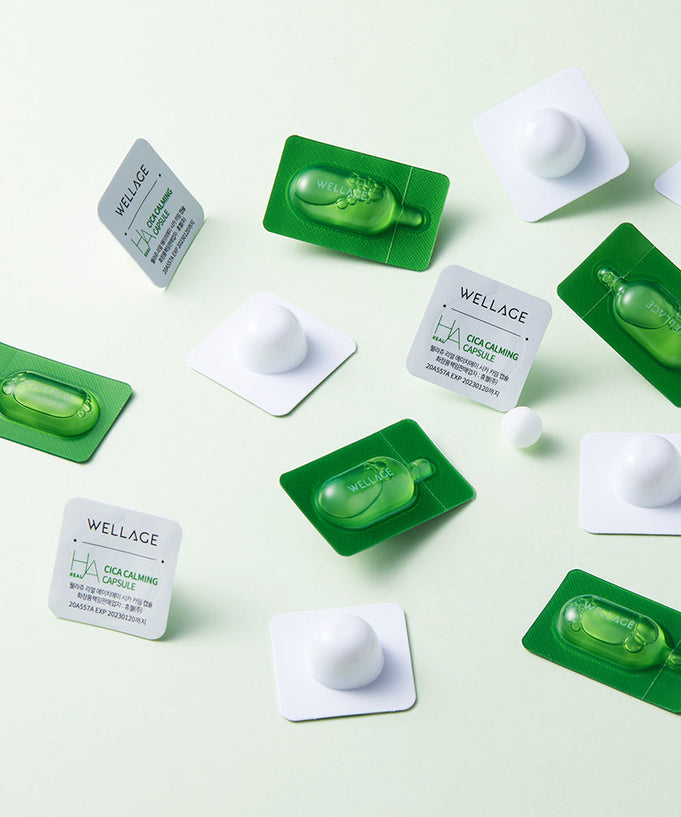 WELLAGE Real Cica Calming One Day Kit on a light green background, featuring individual skincare capsules and packaging.