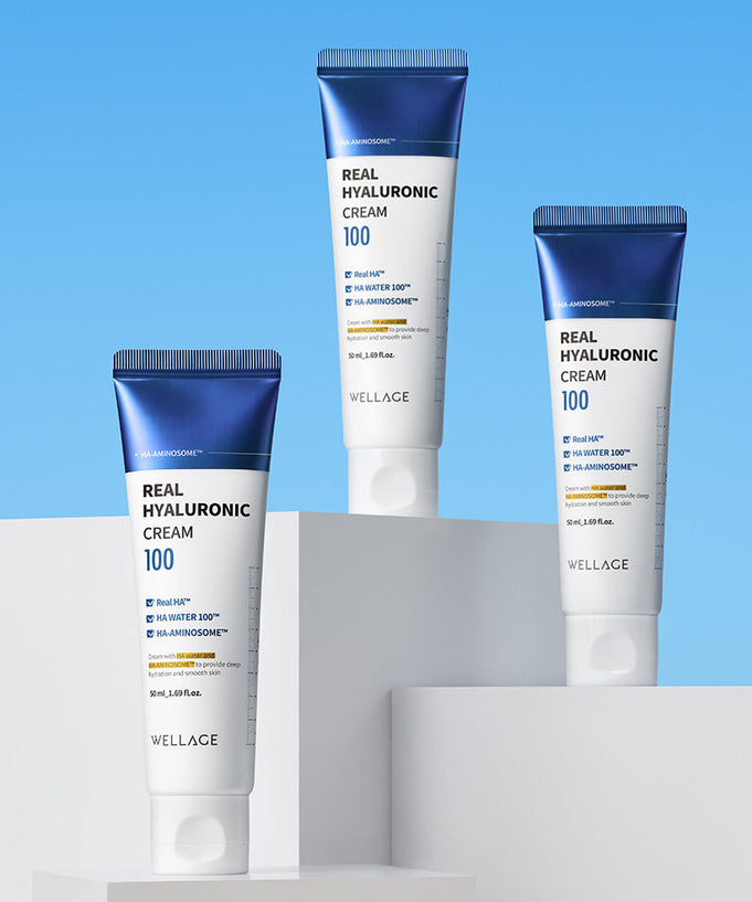 WELLAGE Real Hyaluronic 100 Cream 80ml tubes displayed on stands against blue background