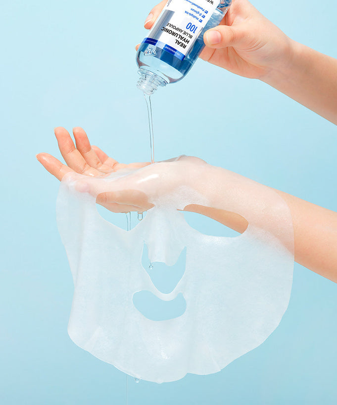 WELLAGE Real Hyaluronic Blue Ampoule Mask 5 Sheets being prepared for use on a hand with a light blue background.