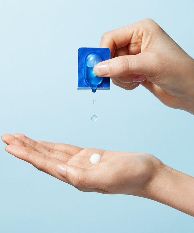 Person using WELLAGE Real Hyaluronic One Day kit with capsule and gel on hand.