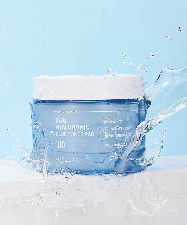 WELLAGE Real hyaluronic Blue Toner Pads 70 Sheets on a light blue background with splashing water for hydration and skincare
