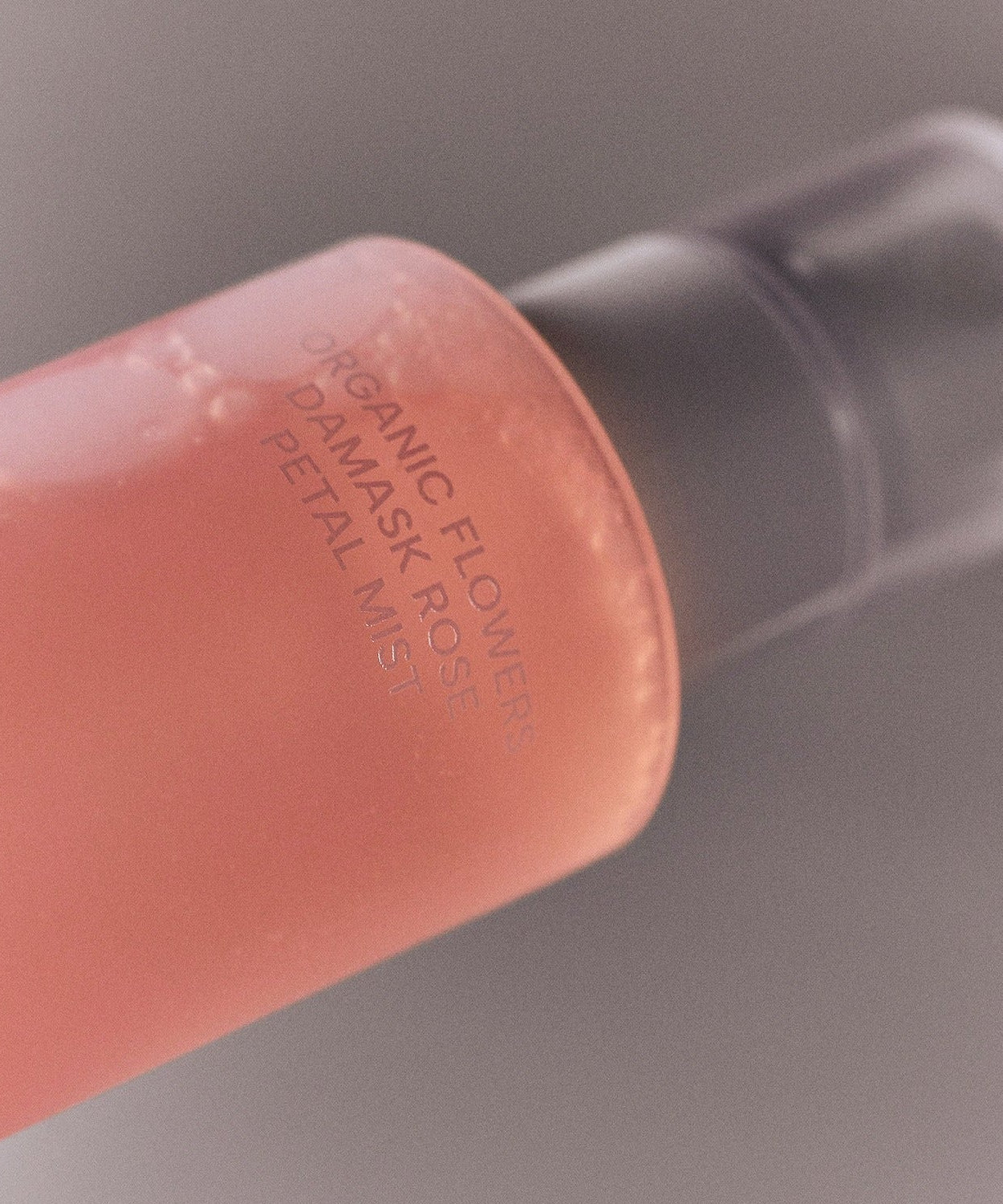 Bottle of WHAMISA Organic Flower Fermented Rose Petal Mist 100ml with pink liquid and pump dispenser