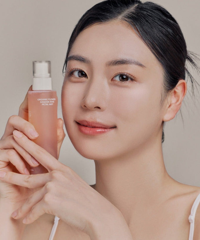 Person holding WHAMISA Organic Flower Fermented Rose Petal Mist 100ml.