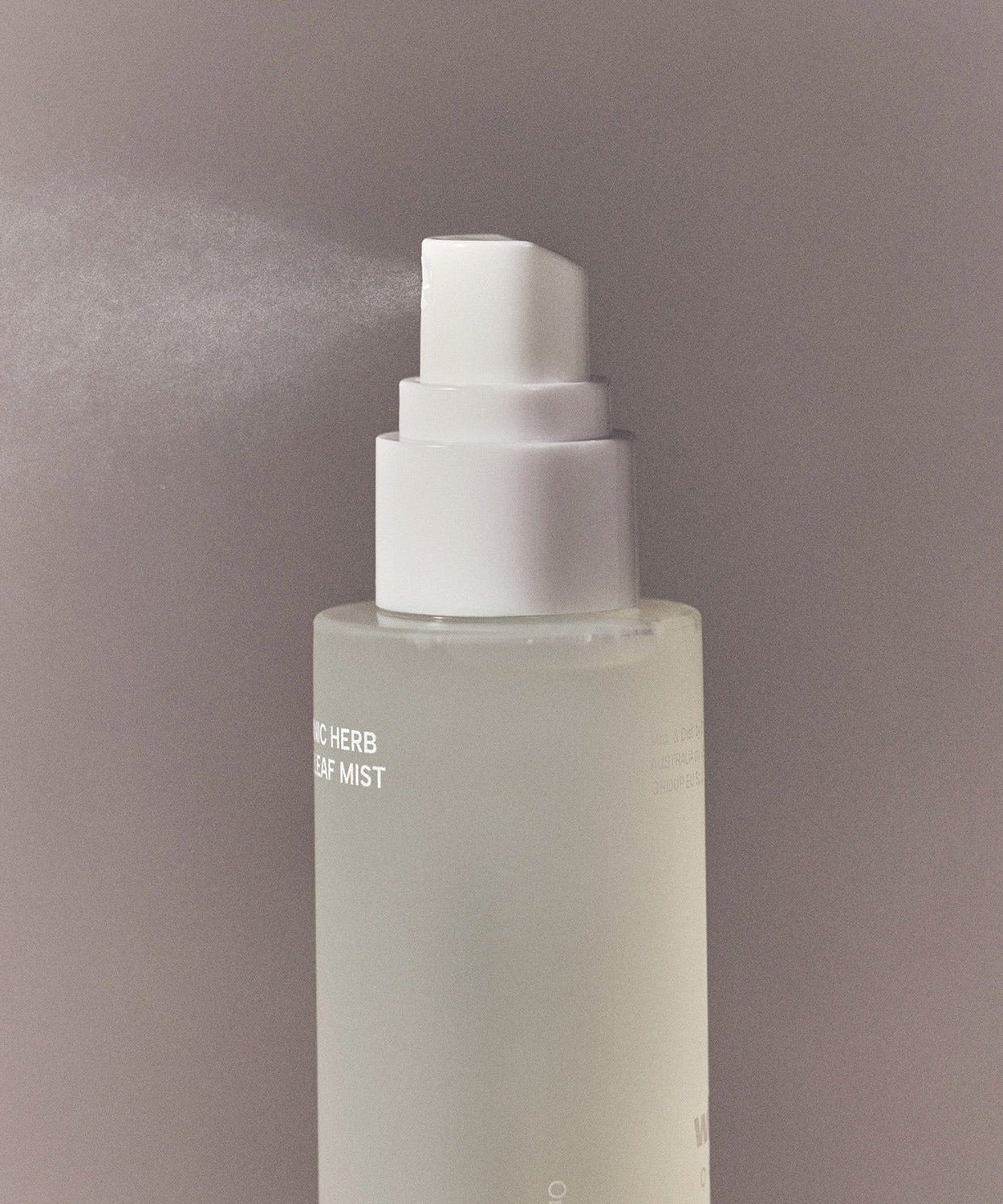 Spray bottle of WHAMISA Organic Herb Fermented Olive Leaf Mist 100ml releasing mist