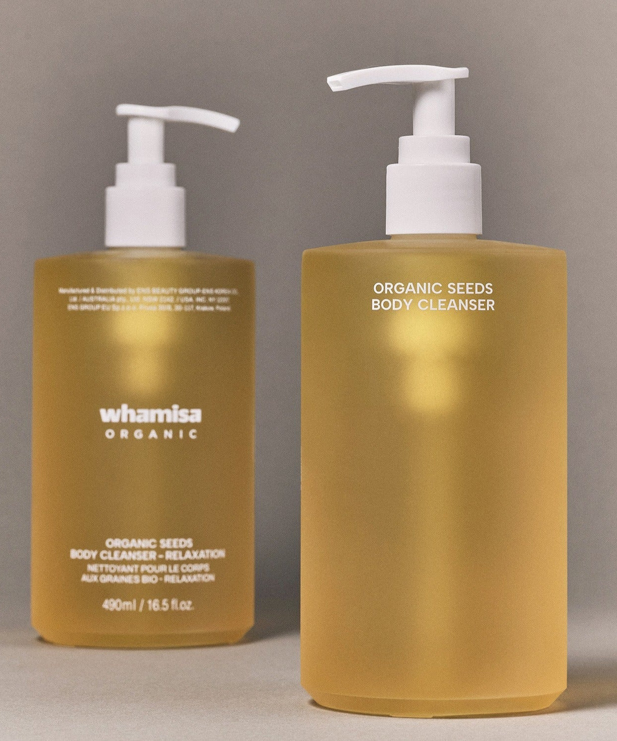 WHAMISA Organic Seed Fermented Body Cleanser 490ml in beige pump bottles on a gray background.