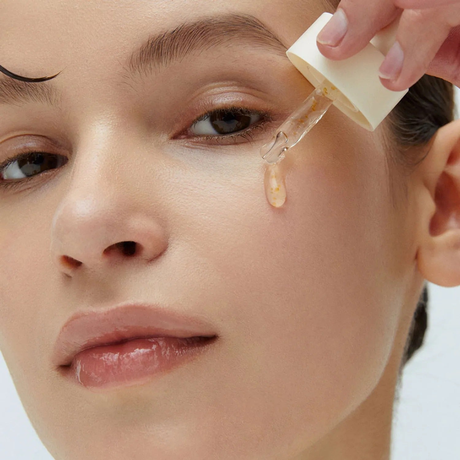 Applying WHIPPED Yujamong Vegan Vita Syrup Ampoule 30ml to skin from dropper