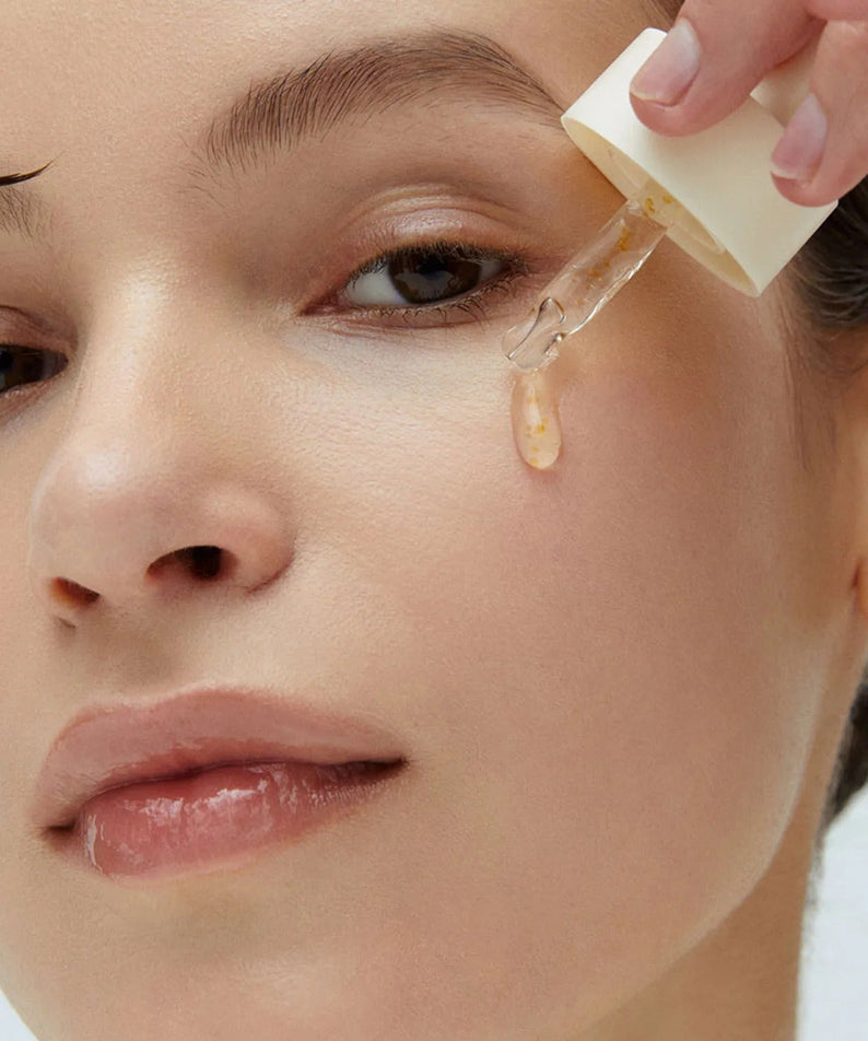 Applying WHIPPED Yujamong Vegan Vita Syrup Ampoule 30ml to skin from dropper