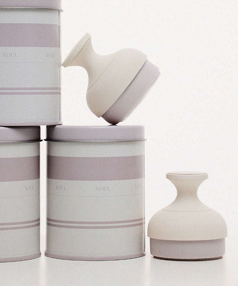 XOUL Silky Smoothing Cleansing Ball next to elegant packaging, showcasing luxury skincare product design.