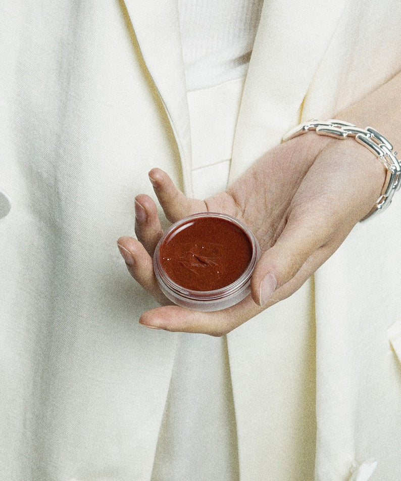 Person holding XOUL Ever Moist Volume Lip Balm 8g in hand, showcasing the smooth texture of the balm.
