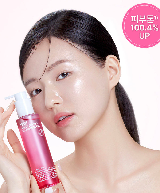 Woman holding ISOI Brightening Cleansing Oil 150ml with glowing skin for enhanced skincare routine