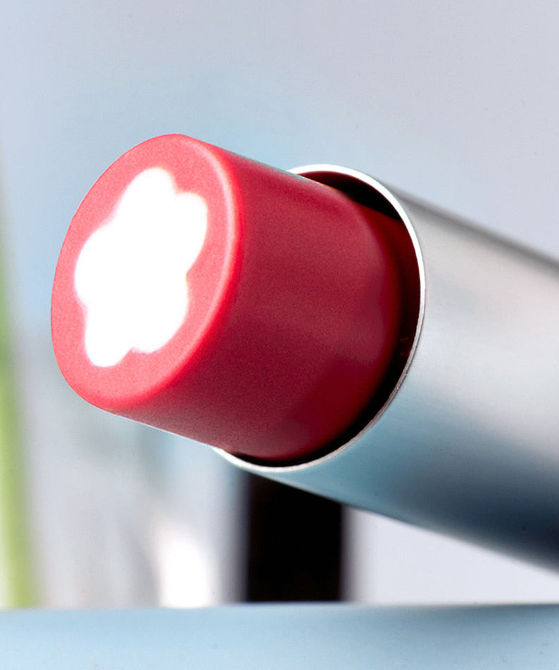 Close-up of ROMAND x Joanne Friends Glasting Melting Balm lipstick with flower pattern, showcasing texture and vibrant color.