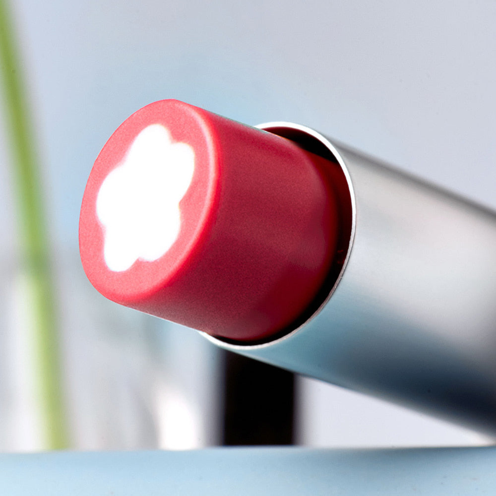 Close-up of ROMAND x Joanne Friends Glasting Melting Balm lipstick with flower pattern, showcasing texture and vibrant color.