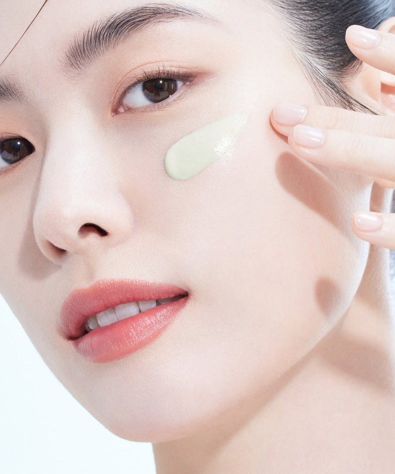 Woman applying AMELI Complement Series Charok Filter 50ml on face