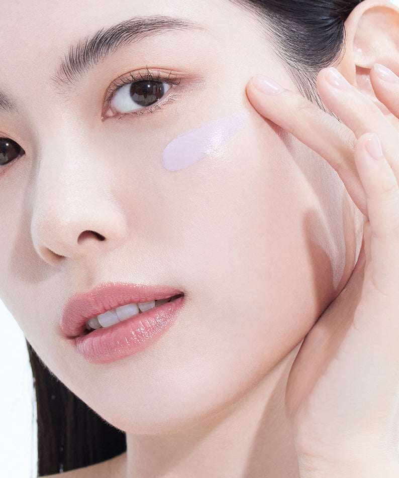 Woman applying AMELI Complement Series Bora Filter 50ml, showcasing smooth skin texture.