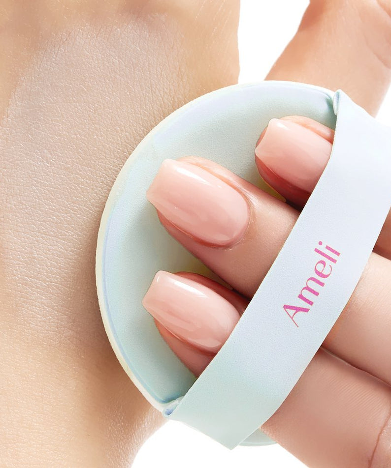 Applying AMELI Complement Series Cushion SPF42 PA++ Green with puff on skin, highlighting smooth finish and sun protection benefits