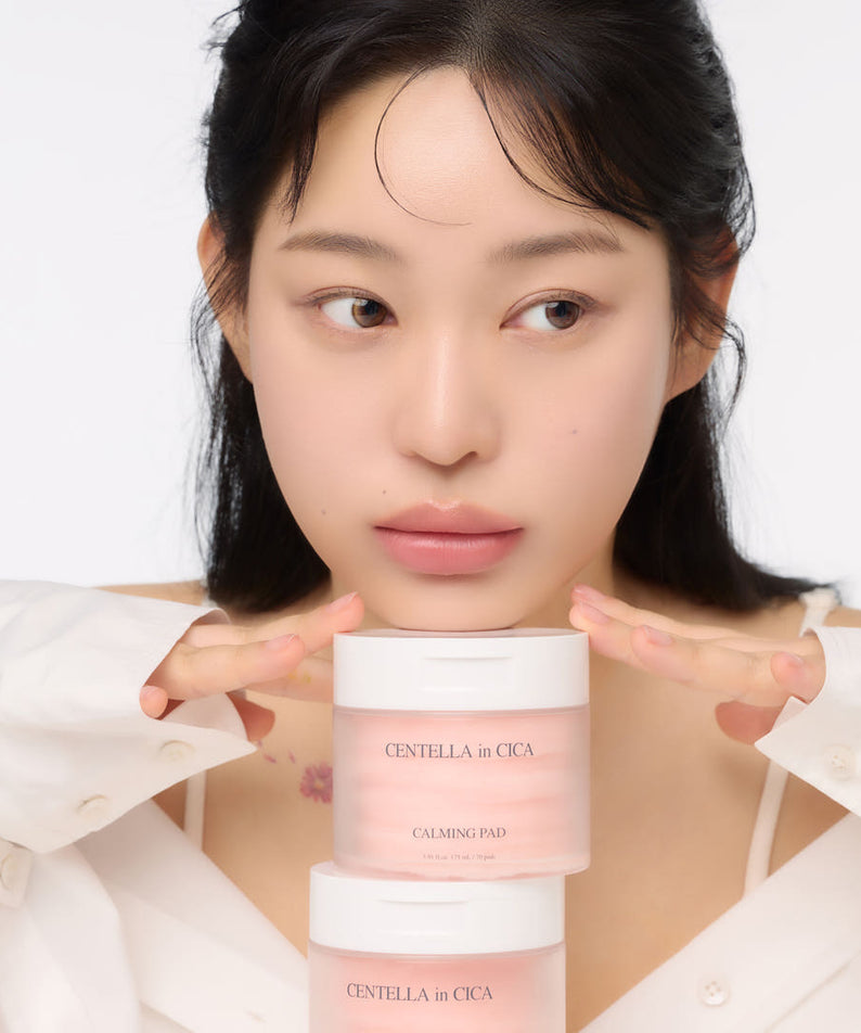 Woman holding AND:AR Centellian in Cica Calming Pads, 70 sheets, skincare product on display