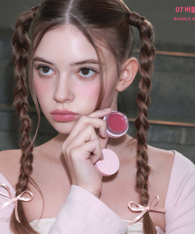 AOU Glowy Tint Balm shown in compact design, enhancing natural beauty with a subtle glow.