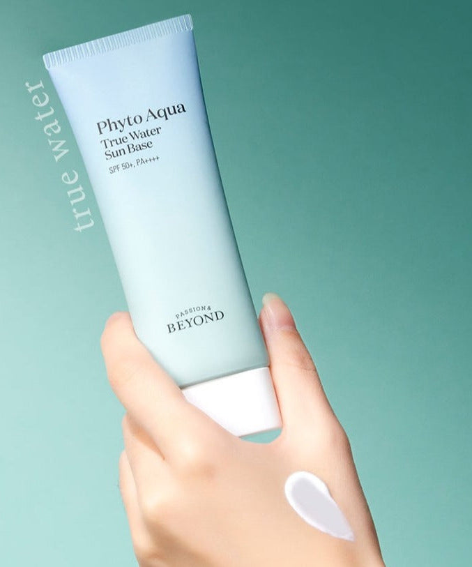 PASSION & BEYOND Phyto Aqua True Water Sun Base SPF50+ held by a hand with cream texture visible