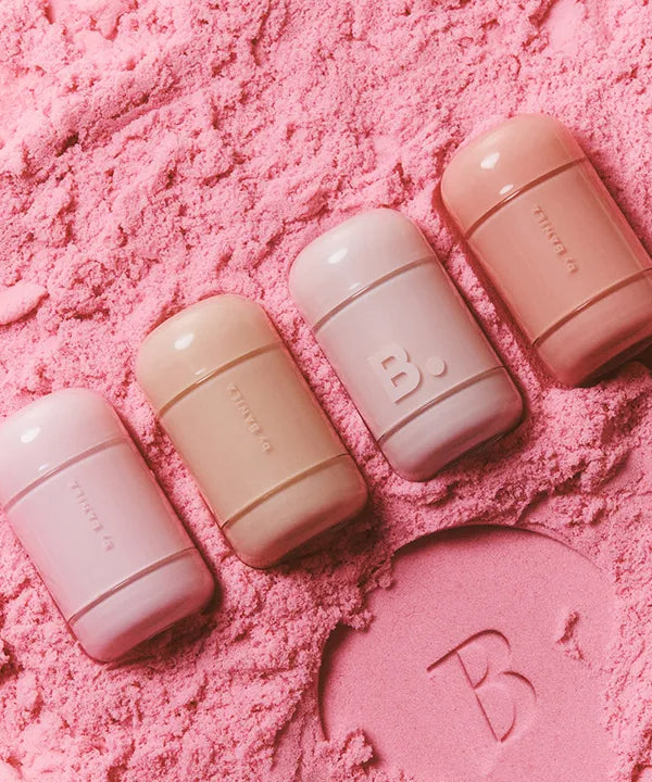 BANILA CO Romantic Blush Lip & Cheek products arranged on pink powder background.