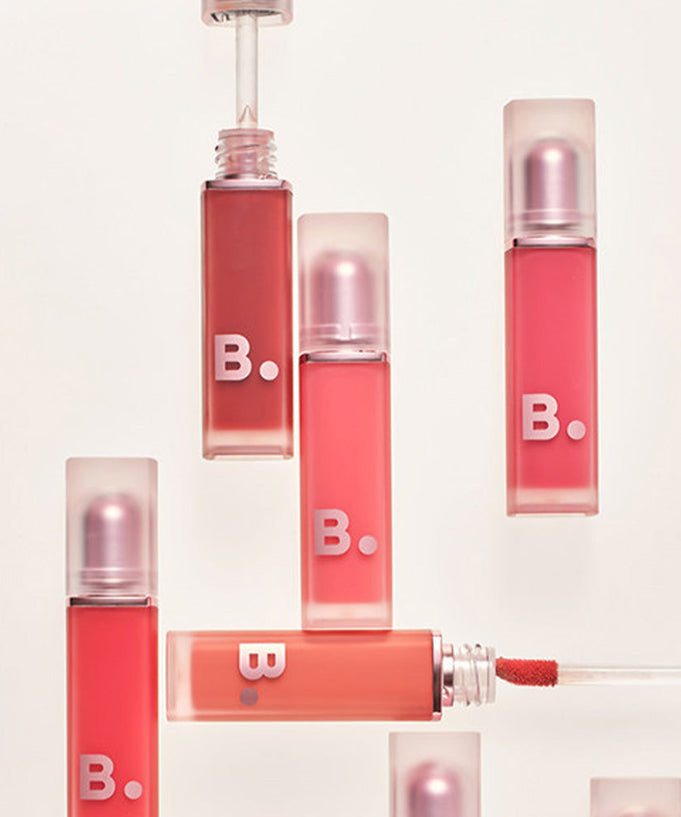 Assorted shades of BANILA CO New Sheer Velvet Veil Tint lipsticks.