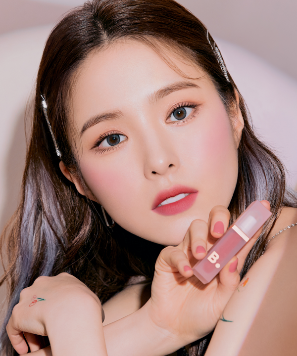 Model holding BANILA CO Water Drop Veil Tint showcasing makeup look