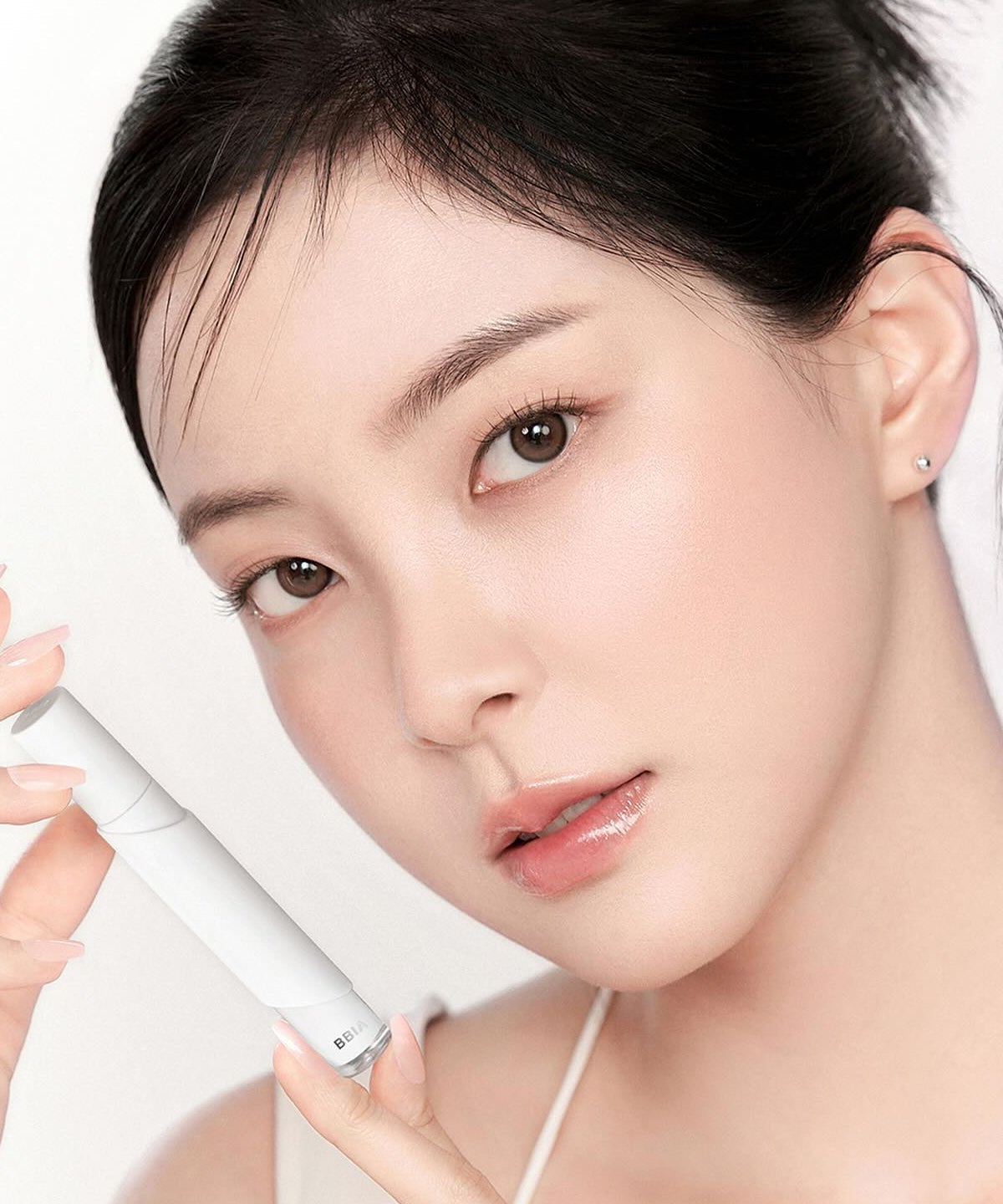 Model holding BBIA Eau Stay Concealer for flawless complexion
