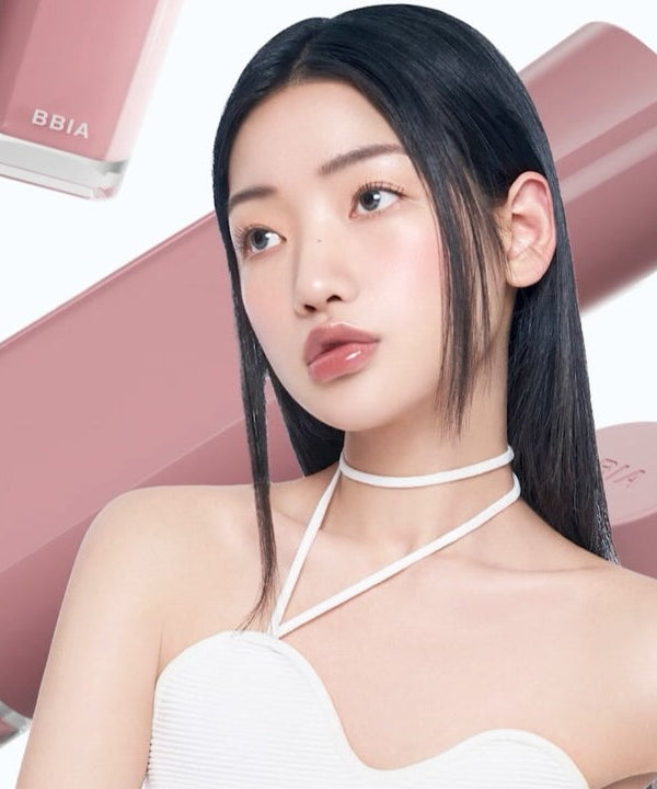 BBIA Glow Tint lipstick behind model showcasing glossy lip color.