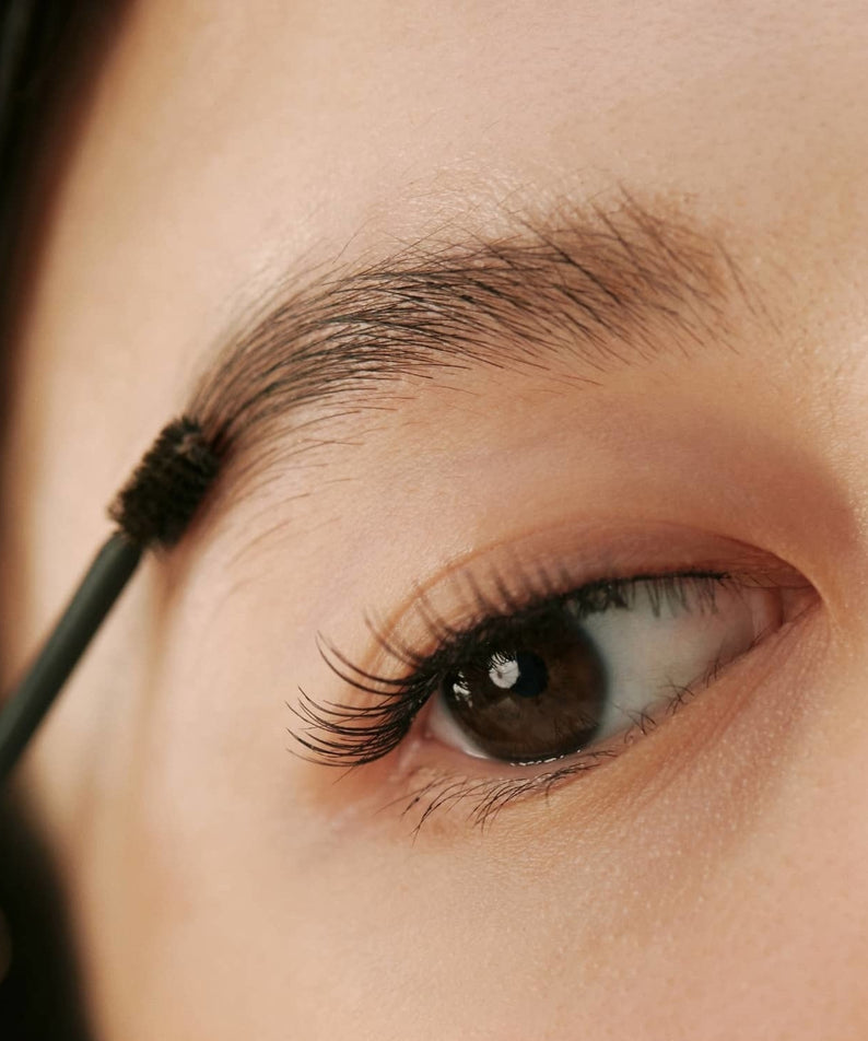 Applying HINCE Signature Brow Shaper on eyebrow for precise grooming