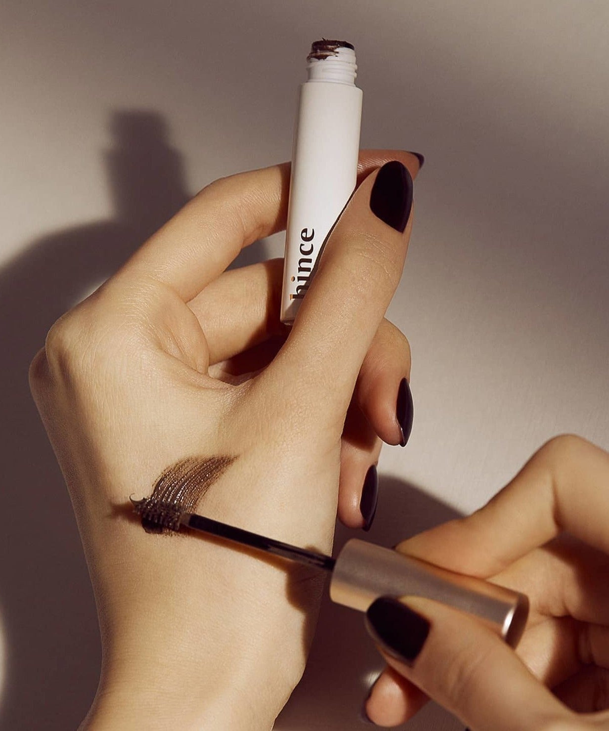Applying HINCE Signature Brow Shaper with brush for styling