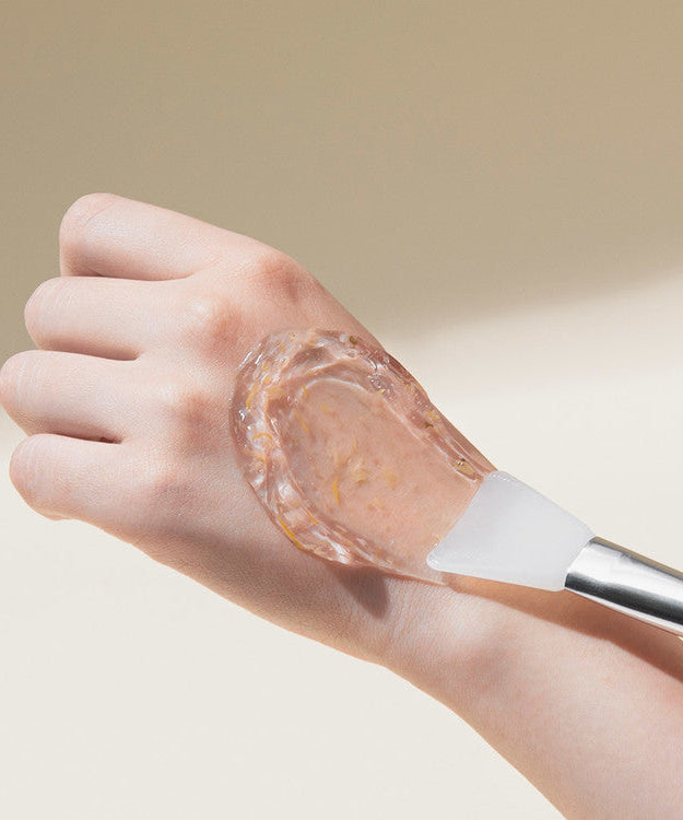 Application of MARY & MAY Calendula Peptide Ageless Sleeping Mask 110g on hand with spatula