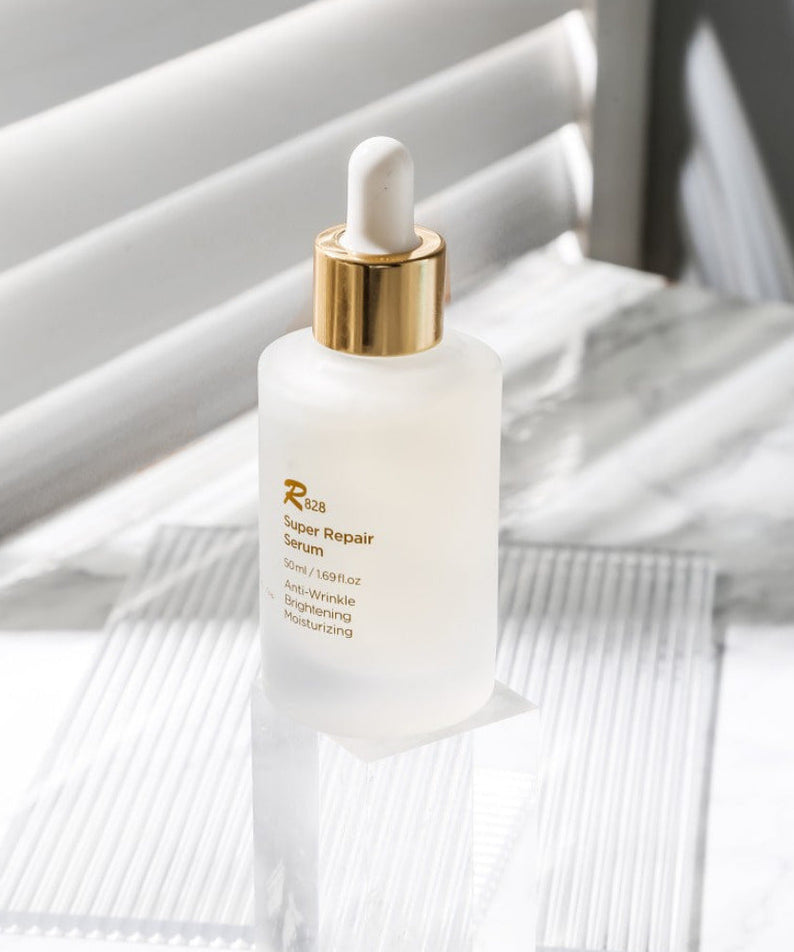 R828 Super Repair Serum 50ml bottle on a white background with a dropper, highlighting its anti-wrinkle and moisturizing benefits.